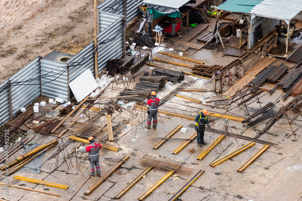 Site at a construction site for the manufacture of frames and storage of materials and formwork for a monolithic reinforced concrete house. View from above. Site at a construction site for the manufacture of frames and storage of materials and formwork for a monolithic reinforced concrete house. View from above.