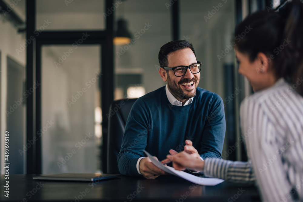 Fototapeta premium Portrait of a smiling businessman, having a meeting with his fem