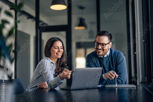 Smiling people, in the meeting room, using a laptop, searching s