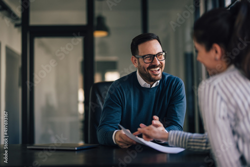 Portrait of a smiling businessman, having a meeting with his fem