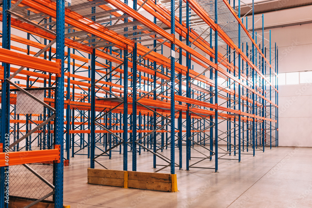 Interior of a modern warehouse, pallets on the floor. Interior of a modern warehouse, pallets on the floor.