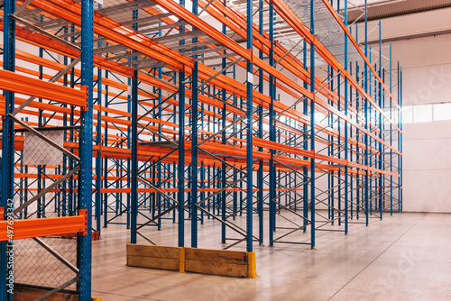 Interior of a modern warehouse, pallets on the floor.
