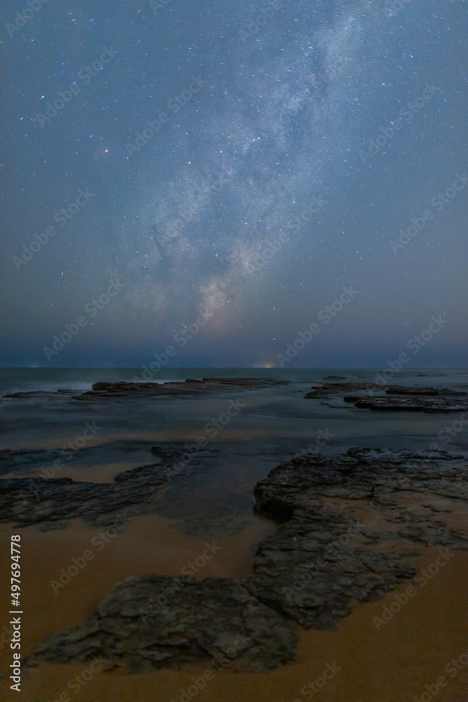Fototapeta premium Milky way galaxy over the rocky coastline.