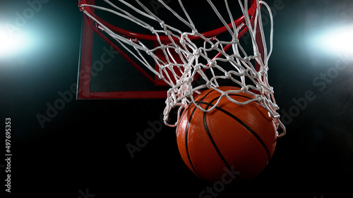 Basketball going through the basket on black backgorund © Jag_cz