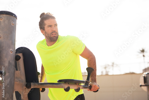 Young muscle man training outside. Fit handsome man doing exercise.. © JustLife