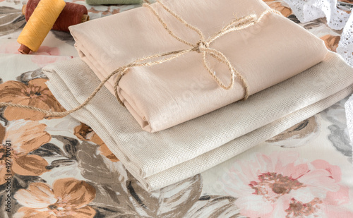 Natural fabrics of beige shades for needlework. Vintage fabric background