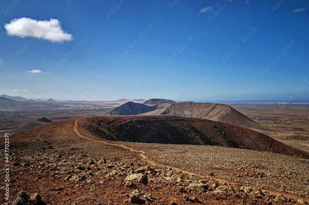 View from the top of volcano in Fuerteventura. Famous Volcanes de Bayuyo. Hiking in Canary Islands.