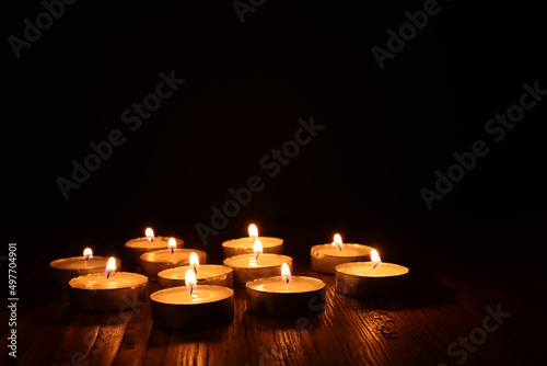 Fotografia Burning candle over black background