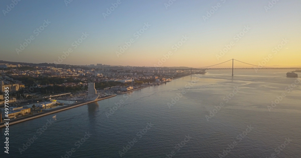 Fototapeta premium Alfama with pattern of discoveries in front and bridge 25 April at background