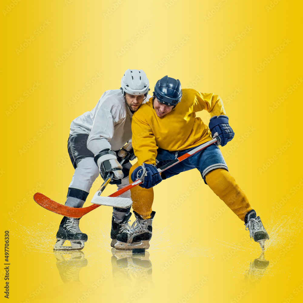 Professional ice hockey player hitting puck for winning goal in action on gradient multicolored neon background. Concept of sport competition. Professional ice hockey player hitting puck for winning goal in action on gradient multicolored neon background. Concept of sport competition.