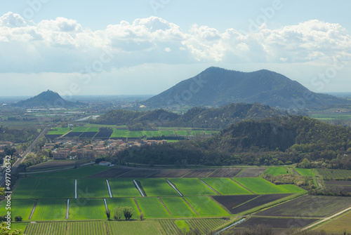 Walk on Monte Ceva. Aerial view on the Euganean hills with cultivated fields. Light haze day.