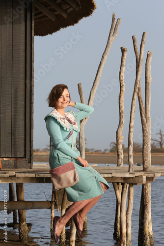 Fashion woman, girl in Senegal, Africa. Lodge Les Collines De Niassam. Tourist woman and Africa nature, landscape, pelicans. Senegalese landmark, scenery. Tourism, travel in Senegal, Africa. Palmarin