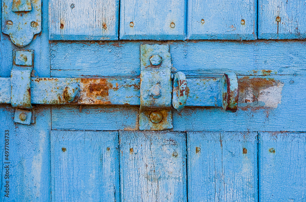 door lock for key closing, keyhole, hasp bolt. Collection of old vintage retro locks on the textured colored door. Close-up door lock for key closing, keyhole, hasp bolt. Collection of old vintage retro locks on the textured colored door. Close-up