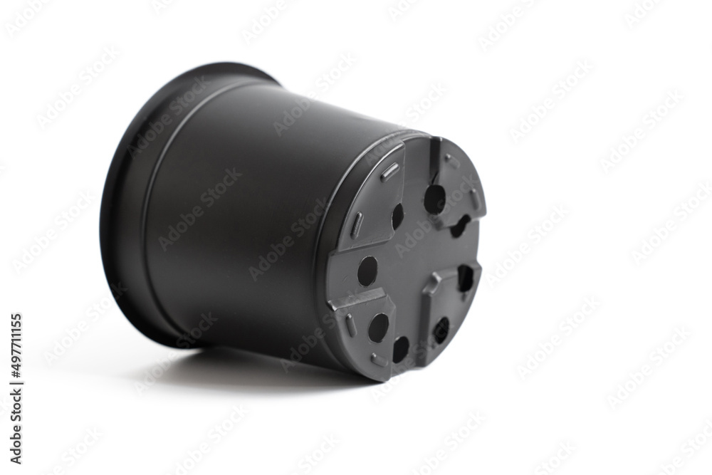 small black plastic pot for indoor flowers on a white background. accessories for seedlings of plants at home. small black plastic pot for indoor flowers on a white background. accessories for seedlings of plants at home.