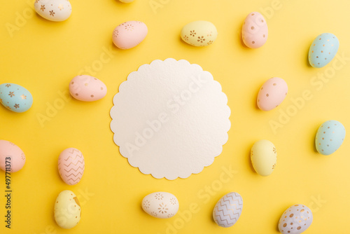 Easter mockup. Colorful easter eggs and decor on a yellow background. Holiday concept with place for text