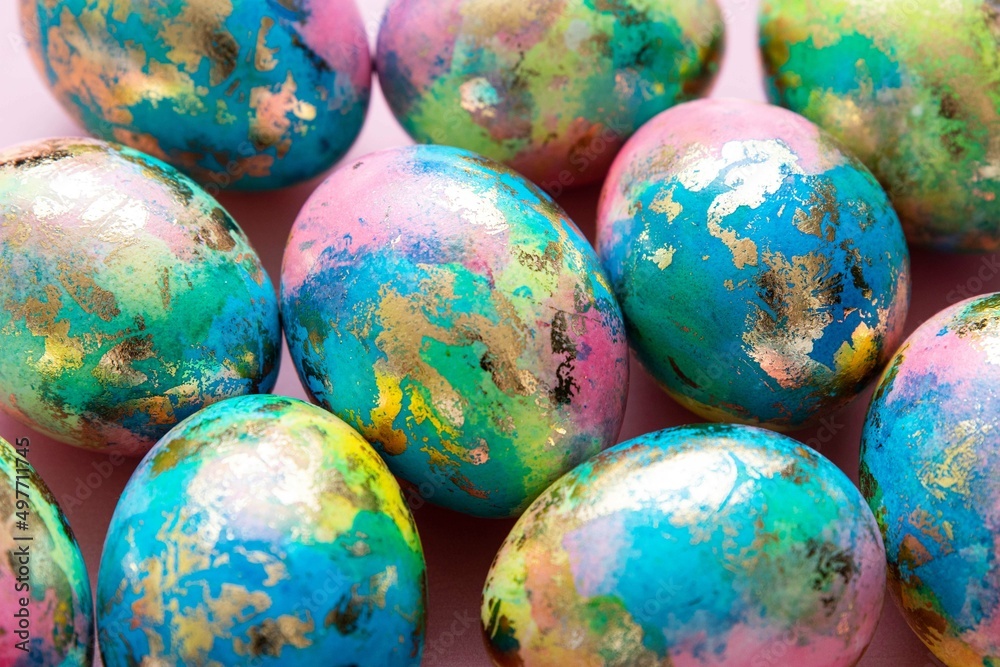 Colorful easter eggs background. Blue, yellow, pink, gold eggs. Selective focus. Colorful easter eggs background. Blue, yellow, pink, gold eggs. Selective focus.