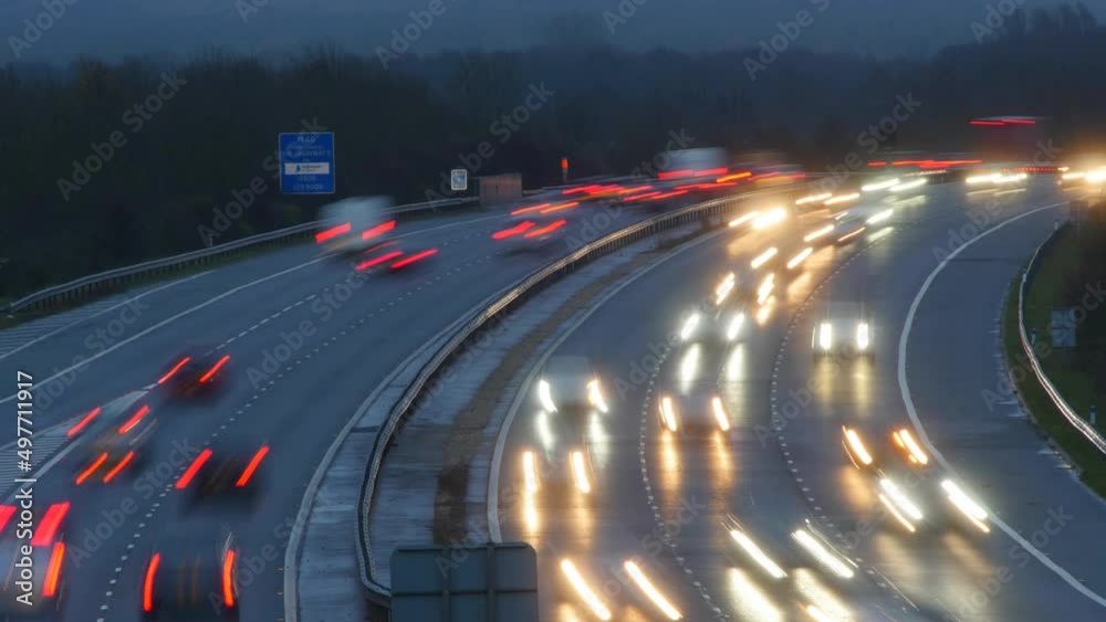 Trails of light on a motorway. Time lapse traffic in the evening. Rain Trails of light on a motorway. Time lapse traffic in the evening. Rain