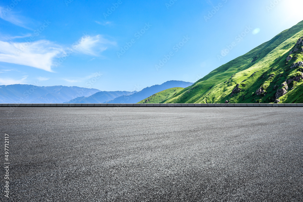 Empty asphalt road and green mountain nature landscape under blue sky. Road and mountains background. - obrazy, fototapety, plakaty 