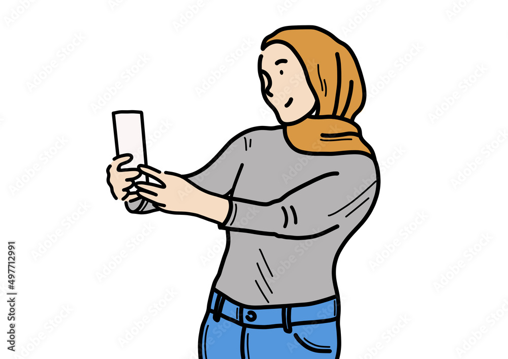 携帯電話を掲げているイスラム系の女の人。
