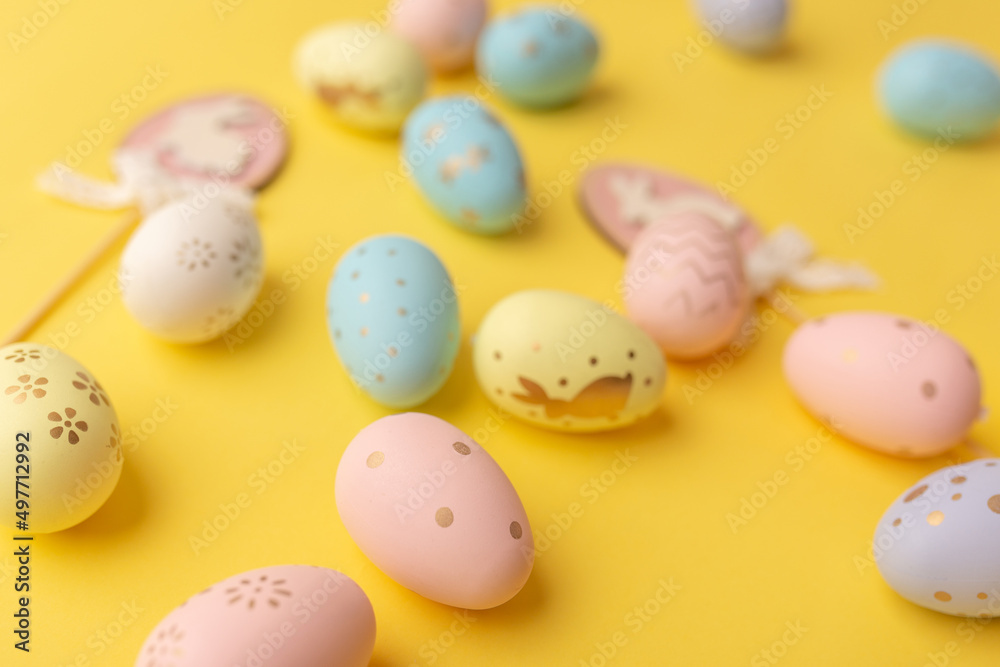 Easter colorful eggs on a yellow backgroun. Top view. Easter card Easter colorful eggs on a yellow backgroun. Top view. Easter card