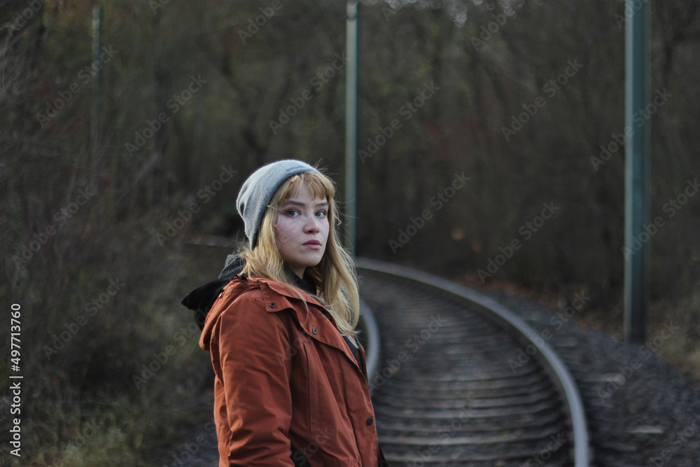 A female hiking, with a railroad in the background A female hiking, with a railroad in the background