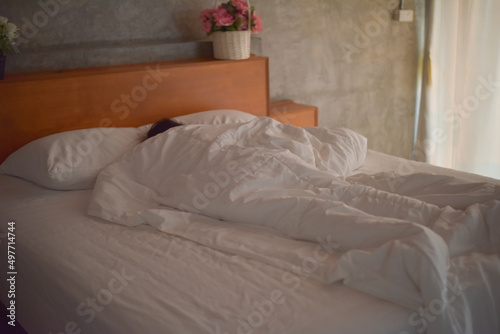 Fototapeta Naklejka Na Ścianę i Meble -  Blurred women sleeping on white bed.