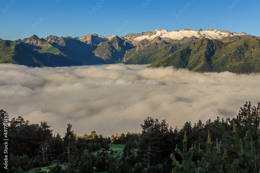 Snowy mountains on the peaks with sea of white clouds