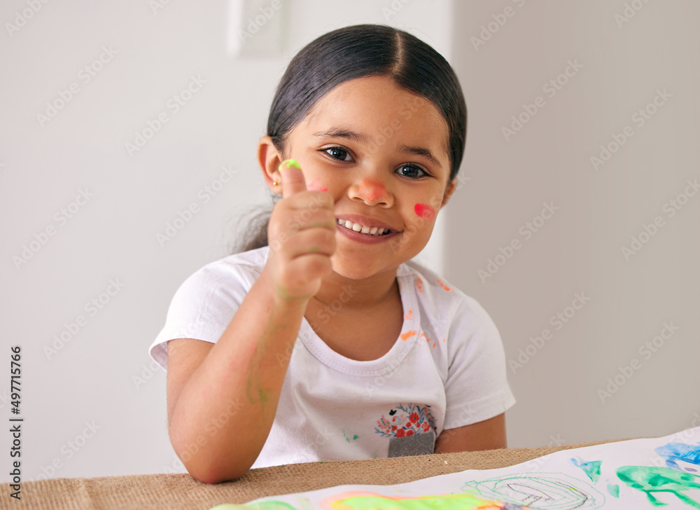 If it involves being creative, Im in. Shot of an adorable little girl showing thumbs up while painting. If it involves being creative, Im in. Shot of an adorable little girl showing thumbs up while painting.