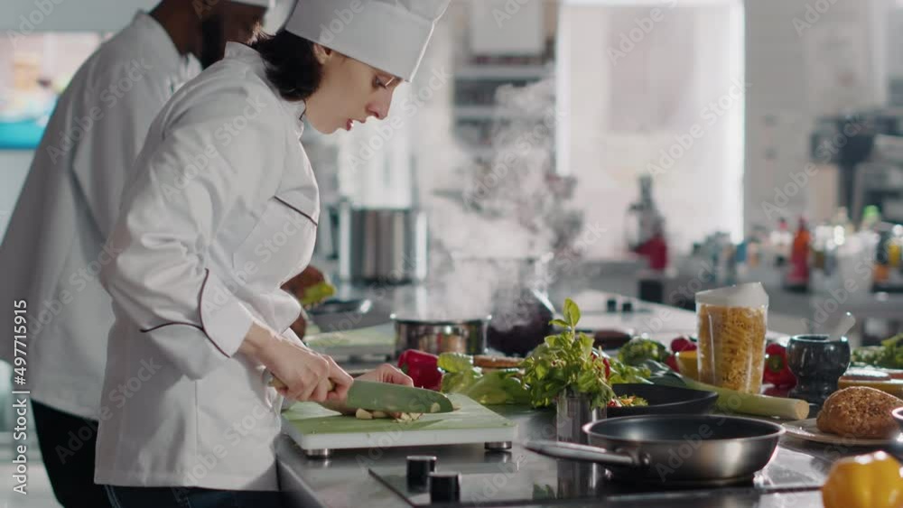 Authentic chef preparing garlic clove to add on delicious food, cooking
