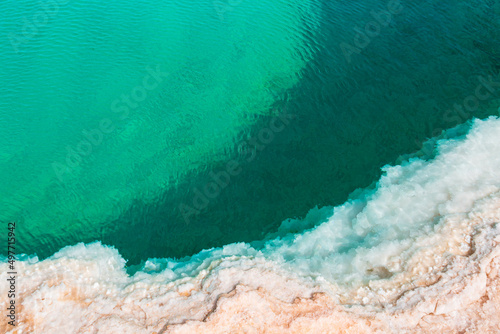 Natural Salt water lake in desert. Oasis in Siwa, Egypt. Tourism spot in Egypt. Closeup turquoise water and white salt photo