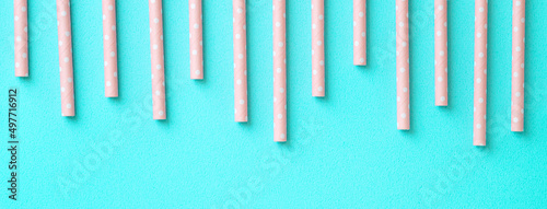 Biodegradable paper straw set on blue table background.