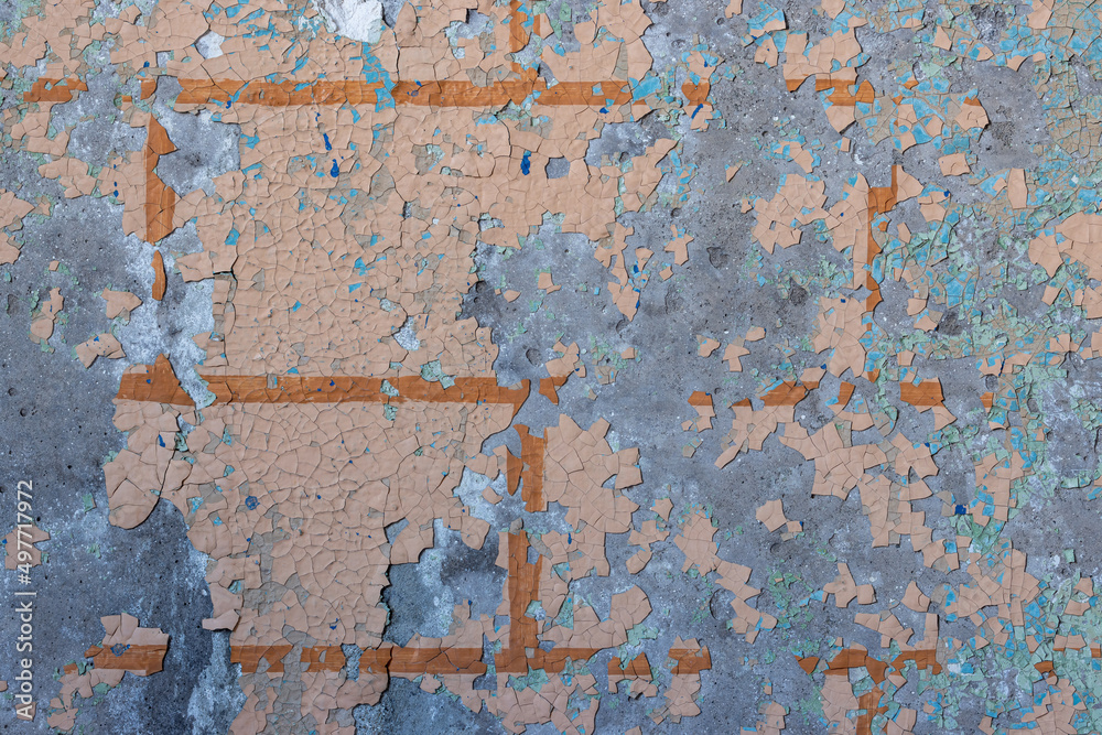 Peeling paint on the wall. Old concrete wall with cracked flaking paint. Weathered rough painted surface with patterns of cracks and peeling. Grunge texture for background and design. High resolution.