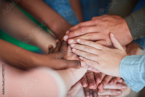 Teamwork will get it done. High angle shot of university students hands in a huddle. © Daniel Laflor/peopleimages.com