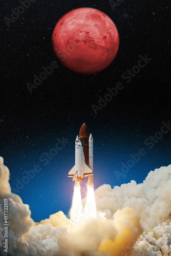 Fototapeta Naklejka Na Ścianę i Meble -  Spaceship lift off. Space shuttle with blast and smoke takes off to the red planet mars. Mars concept. Spacecraft lift off to explore other planets. Elements of this image furnished by NASA.
