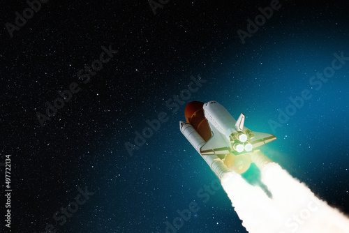 Fototapeta Naklejka Na Ścianę i Meble -  Spaceship lift off. Space shuttle with smoke and blast takes off into the starry sky. Rocket starts into space. Concept. Elements of this image furnished by NASA.