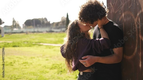 romance, love - young embraced couple in love kissing at park