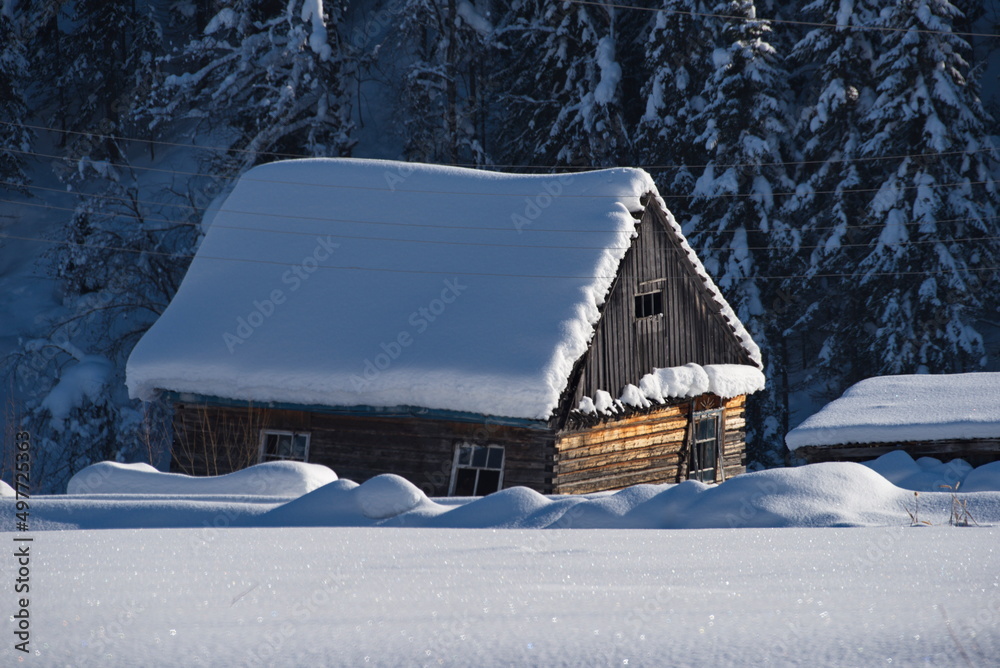 Russia. The South of Western Siberia, the Altai Mountains. A sunny winter day in an abandoned village near the village of Turochak. Russia. The South of Western Siberia, the Altai Mountains. A sunny winter day in an abandoned village near the village of Turochak.