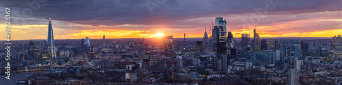 Wide panorama of the London skyline during a colorful sunset: from the City along the river Thames until Westminster district