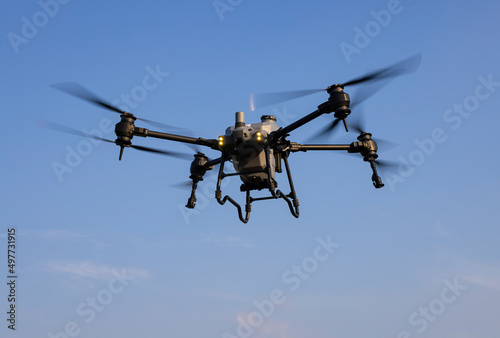 Fototapeta Naklejka Na Ścianę i Meble -  Agriculture drone flying in the blue sky background