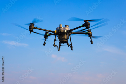 Agriculture drone flying in the blue sky background