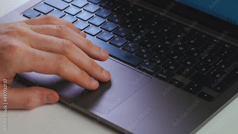 a man uses a laptop touchpad a man uses a laptop touchpad