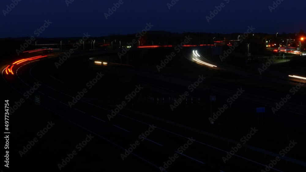 Busy time lapse traffic at night. Curves of light in the darkness Busy time lapse traffic at night. Curves of light in the darkness