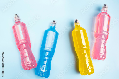Plastic bottles with colored liquid. Colored bottles of sports nutrition, isotonics.
