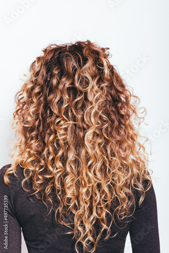 Rear view of redhead naturally curly hair photo