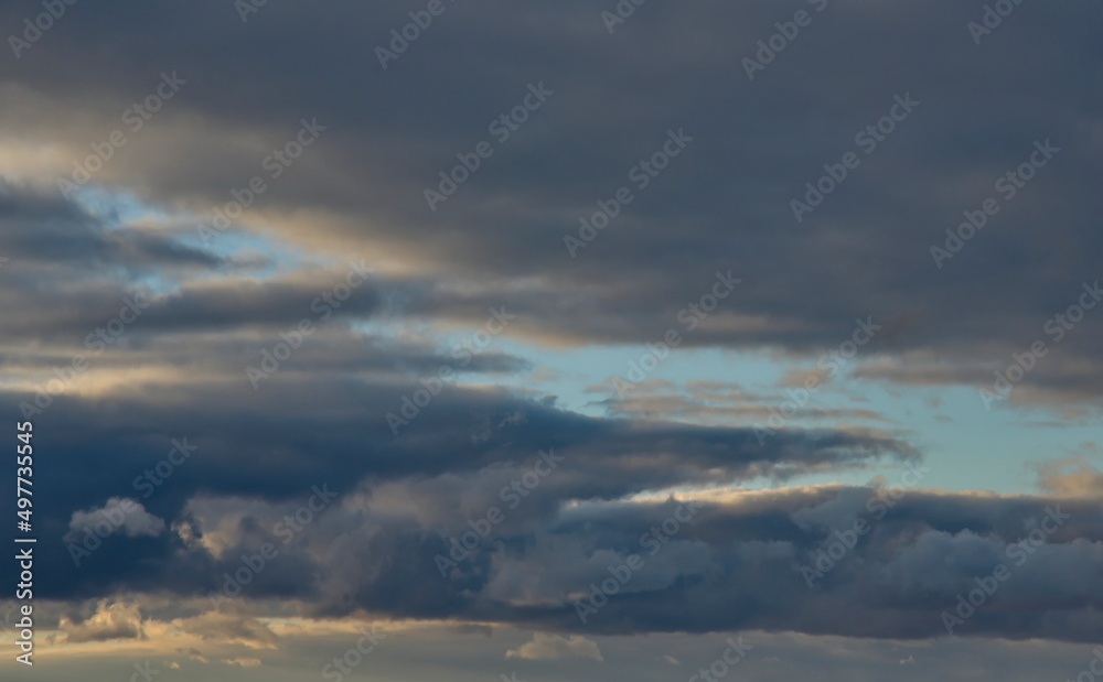 Russia. The South of Eastern Siberia. Gloomy sunset clouds in the evening summer sky over the mountain ranges of Eastern Sayan.