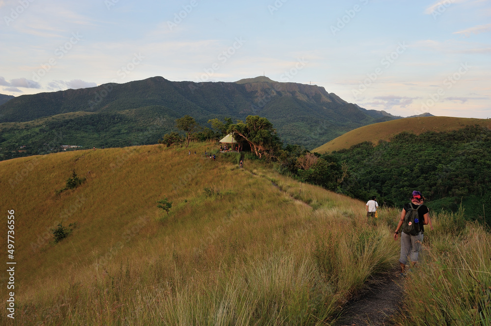 People walking down a hill to reach viewpoint at Mount Taypas, Coron, Philippines. 