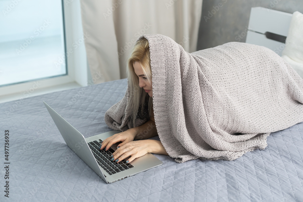 Bored woman resting and lying on couch take break, watching movie, working on laptop at home in living room. Lazy weekend. Bored woman resting and lying on couch take break, watching movie, working on laptop at home in living room. Lazy weekend.
