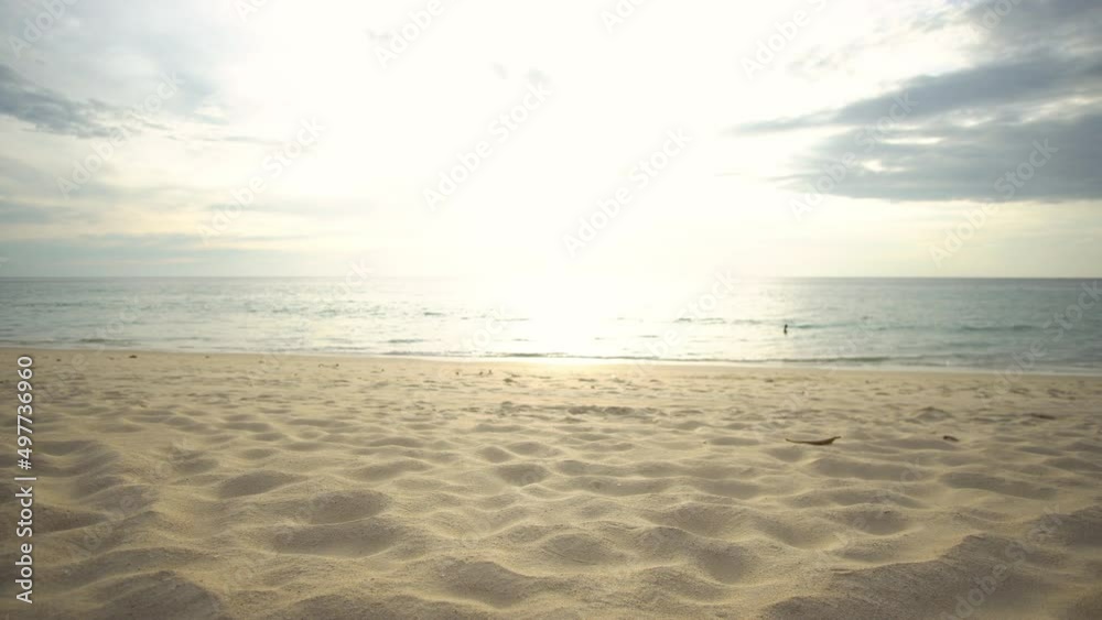 Closeup sand texture dolly shot on beach in sunset on seawater background. At Phuket Thailand.