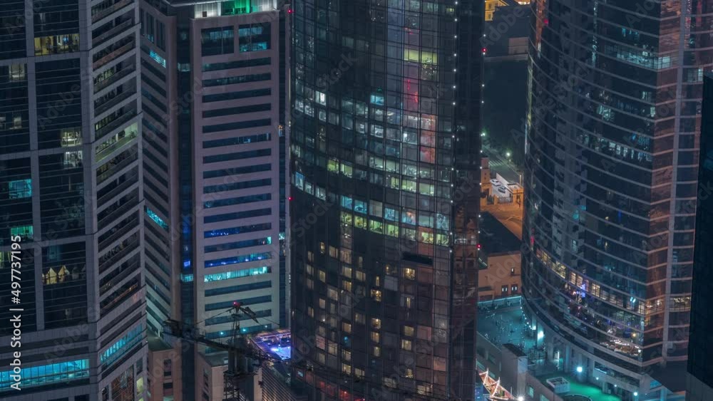 Modern buildings with blue stained glass windows glowing at night in Dubai Media City timelapse, United Arab Emirates Modern buildings with blue stained glass windows glowing at night in Dubai Media City timelapse, United Arab Emirates