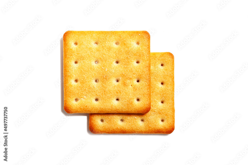 Salty cracker cookies on a white background. A couple of biscuit on the table. Morning breakfast snack. Wheat light meal snack in lunch time. Salty cracker cookies on a white background. A couple of biscuit on the table. Morning breakfast snack. Wheat light meal snack in lunch time.